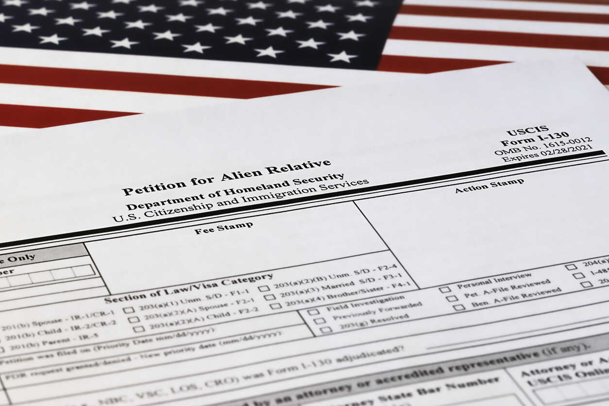 USCIS Form I-130 petition for alien relative with American flag, illustrating concurrent I-130 and I-485 filing risks in 2025