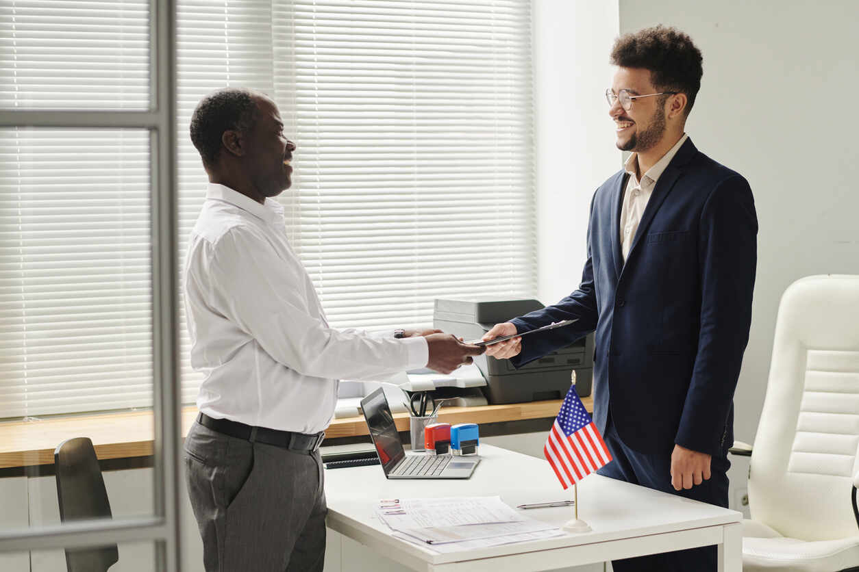Immigration attorney assisting a client during a USCIS interview, showcasing legal support for the immigration process.