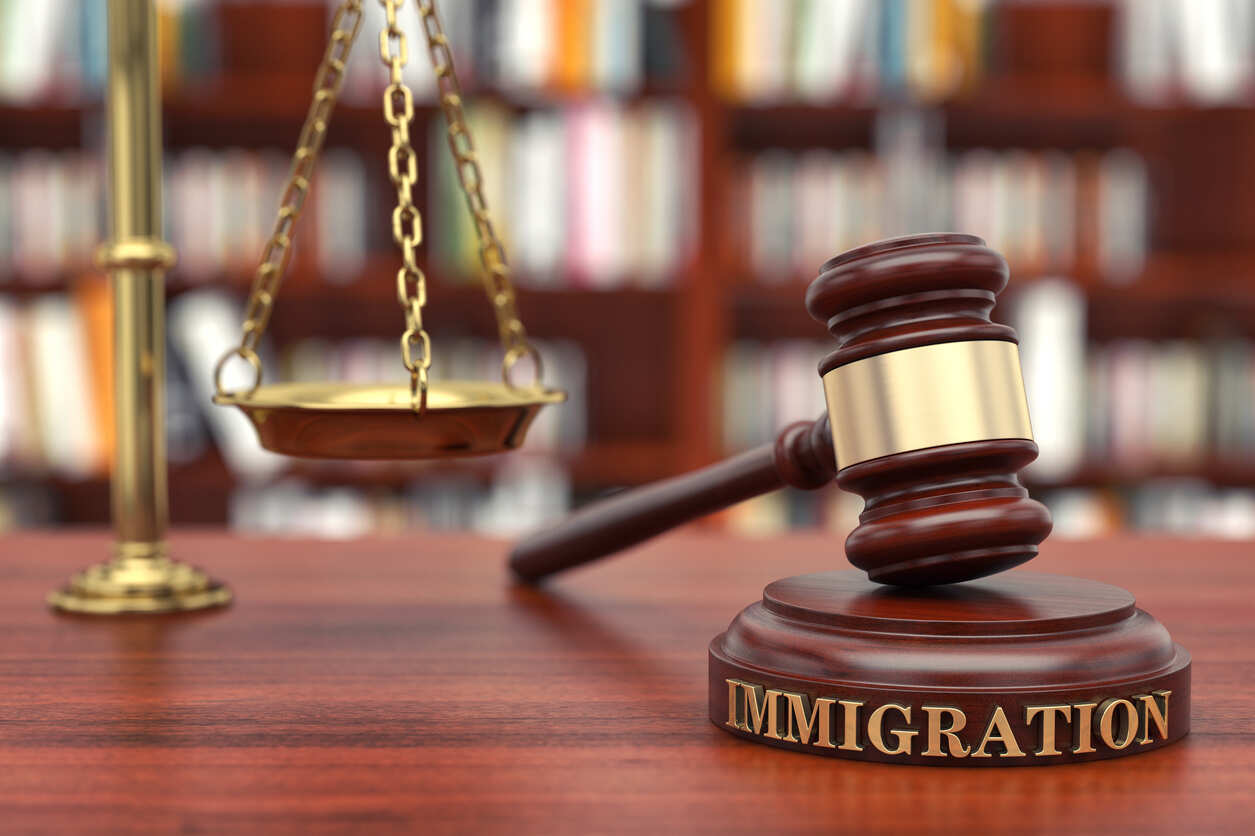 Gavel with 'IMMIGRATION' text and scales of justice, symbolizing F-1 visa legal services.