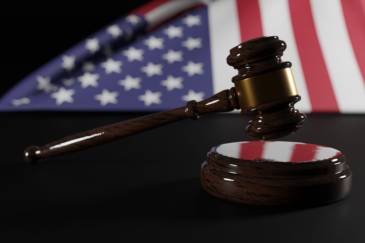 A judge's gavel with an American flag background, symbolizing an I-751 petition for immigration.
